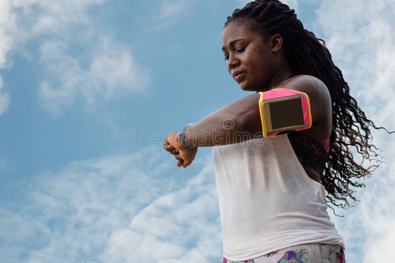 Sporty african woman  sweating after exercising on summer hot day over blue sky background royalty free stock images Sporty african woman  sweating after exercising on summer hot day over blue sky background royalty free stock images